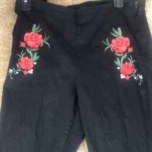 Black pants with flowers.